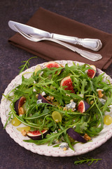 Grapes, figs, blue cheese, arugula and walnuts salad, vertical