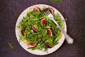 Grapes, figs, blue cheese, arugula and walnuts salad. View from above, top studio shot, horizontal