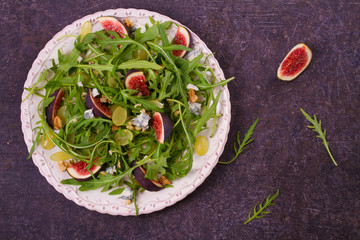 Grapes, figs, blue cheese, arugula and walnuts salad. View from above, top studio shot, horizontal