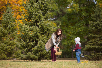 Fototapeta premium mother with her son walks in the autumn park
