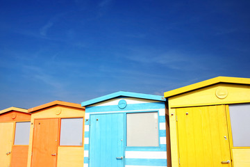Colorful Beach Huts by the Sea in English Countryside