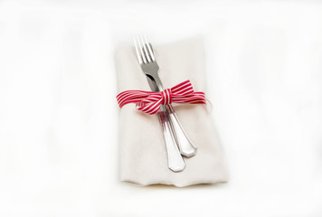 Napkin and cutlery on white background