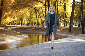 Portrait of a young beautiful woman in gray coat