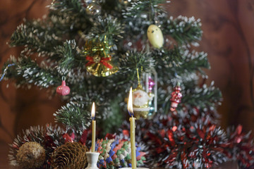 Burning Candle near Christmas Tree. Christmas Background.