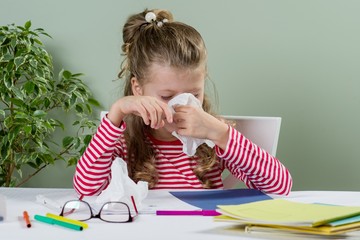 Sad and tired young schoolgirl 7 years old.