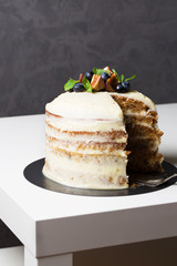 Pumpkin cake with cream cheese, berries, vertical, selective focus