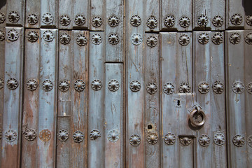 detail of ancient wooden door of church San Mateo, from Fifteenth century, with metal pieces pattern, lock and ring knocker, in Banos de la Encina, Jaen, Andalusia, Spain Europe
