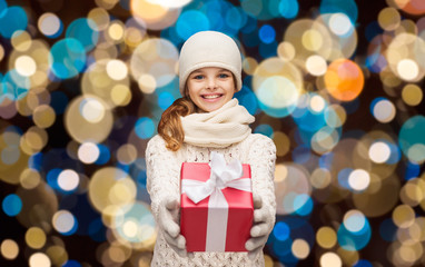 happy girl in winter clothes with gift box