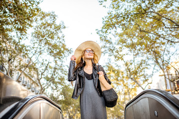 Naklejka premium Young woman tourist in hat walking on the famous pedestrian boulevard in Barcelona city