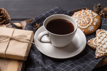 Cup of black coffee with Christmas gingerbread cookies