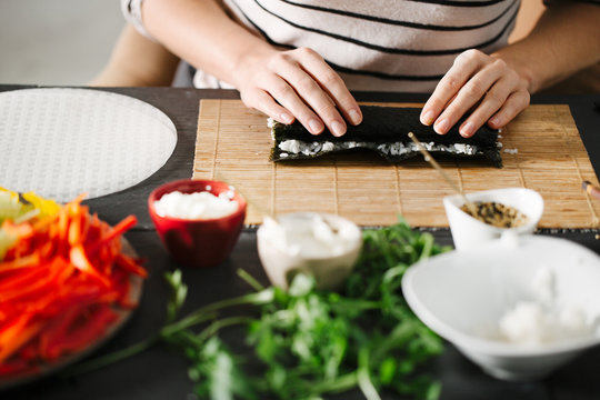Woman Making Veggie Maki Sushi Rolls