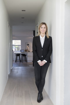 Portrait Of Businesswoman In Black Suit Jacket In Her Stylish Home