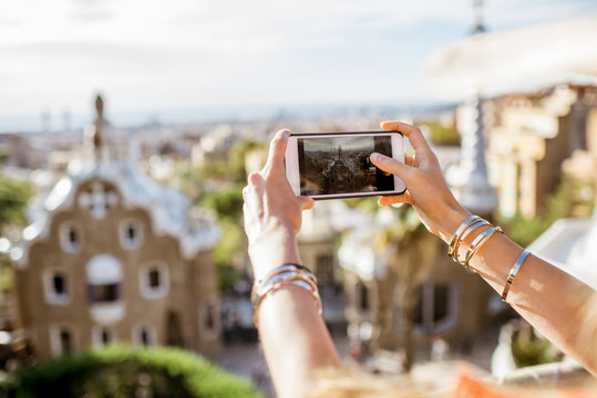 Photographing with phone Guell park in Barcelona city