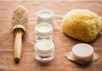 hair brush, cream, sponge, soap bar and bath towel