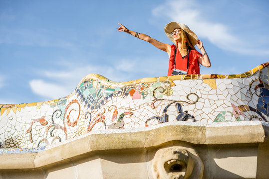 View on the beautiful terrace decorated with mosaic with happy woman tourist in Guell park in Barcelona