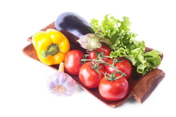 Fresh assorted vegetables, eggplant, bell pepper, tomato, garlic with leaf lettuce. Isolated on white background. Selective focus.