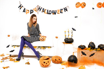young woman with black pumking in Halloween decoration