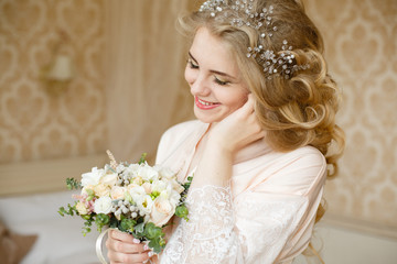 Beautiful young Bride with blonde hairs in a bedroom. Classic white wedding dress. Half-length portrait