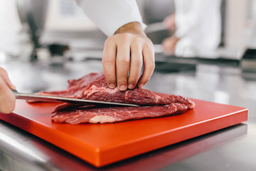 Chef Cutting a Slice of Red Meat