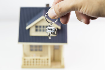Buying new real estate concept, house and key on hand. Protect Your Home Concept 