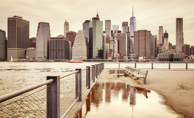 Retro toned Manhattan skyline seen from Brooklyn, New York City, USA.