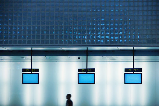 Man walking pass check-in counters at airport