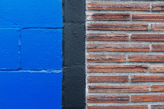 Detail of brick and painted cinderblock wall