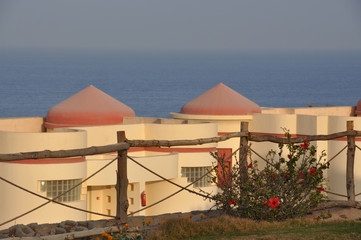 The view of the red sea through the hotel bungalows and wooden fence