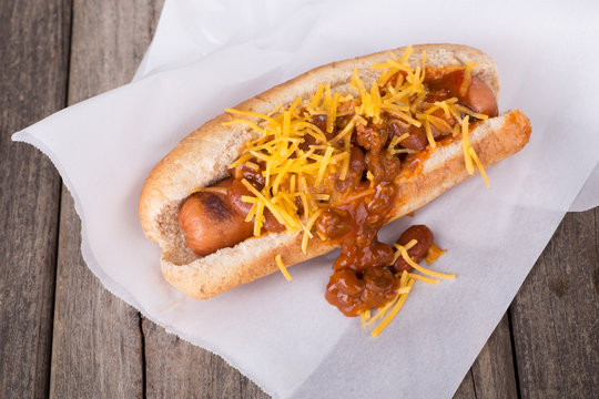 Chili Dog with Cheese on Parchment Paper