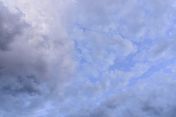 Cloudy sky group with condensation in evening before sunset and raining.
