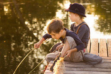 Friendly children sitting with sticks in hands