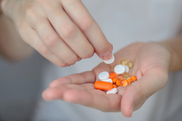 Many pills in the palm of your hand, treatment of the disease