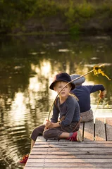 Foto op Canvas Cheerful children sitting with sticks in hands © lanara@bk.ru