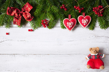 Christmas background with green fir branches, heart and red berries