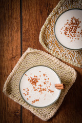 Eggnog houmemade with cinnamon and kakao for Christmas and winter holidays or wooden broun backgrounds