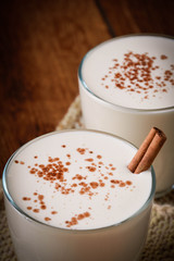 Eggnog houmemade with cinnamon and kakao for Christmas and winter holidays or wooden broun...