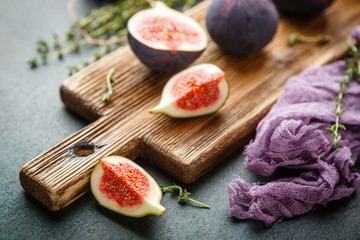 Fototapeta na wymiar Juicy fig fruits on a dark background