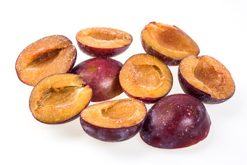 Frozen plum without pit.Macro,frozen organic plum,a handful of sweet,luscious frozen plum isolated on white background,quick-frozen,healthy food.frozen half of a plum,Winter vitamins