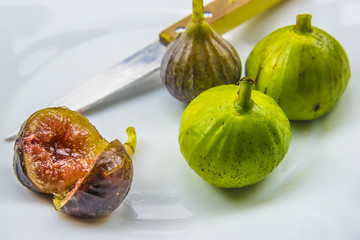 fresh juicy sliced fig on white plate