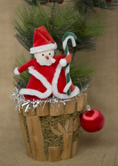 Santa Claus and Christmas Decor Toy Fir Tree Ball on Sackcloth Background Vertical Picture