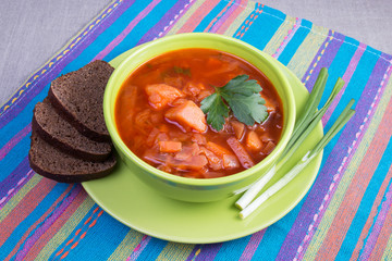 Traditional Russian and Ukrainian beetroot soup borscht with black bread angle view