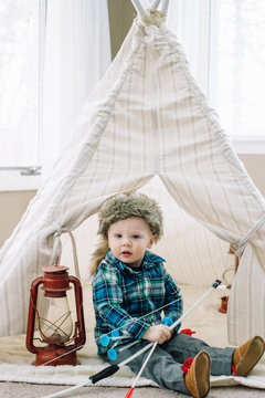 Young child playing in fort