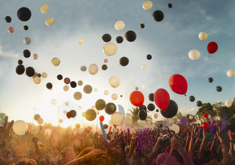 Big festival outdoors with music and balloons