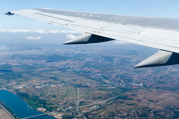 Aircraft is flying high above the city.