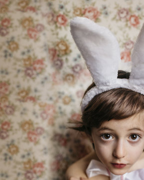 Overhead photo of a boy wearing bunny ears