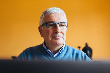 Old man focused on his laptop