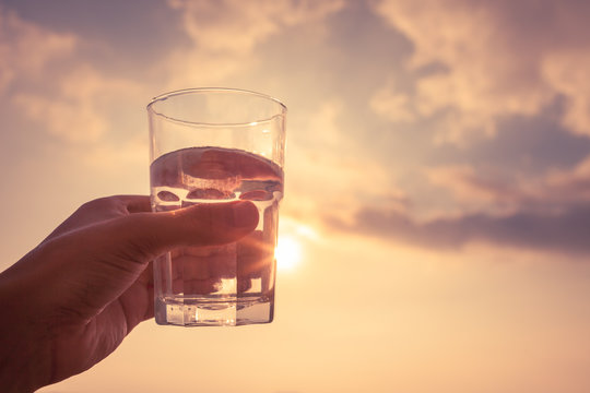 Hand Holding Glass Of Water. 