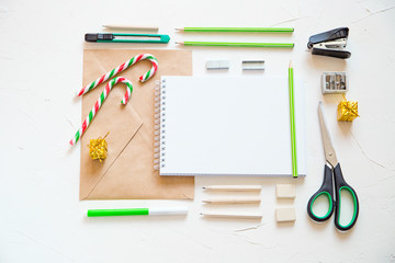 Top view of office supplies and christmas decoration6 writing a letter.