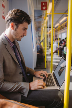 Young business man working in a train
