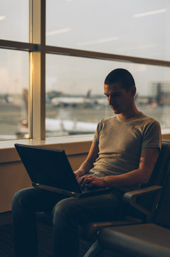 Young Man Working and Waiting for His Flight